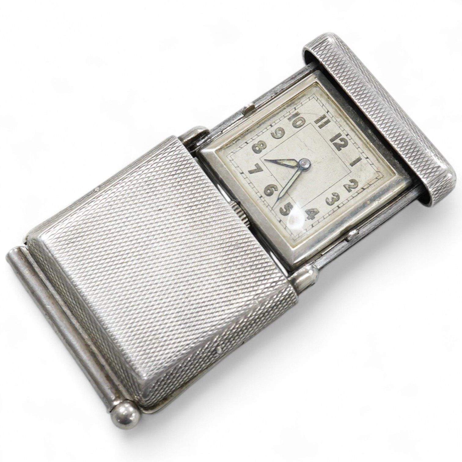 An early to mid 20th century engine turned 935 standard white metal combination travelling watch/pencil holder and notepad section, with Arabic dial, 42mm.